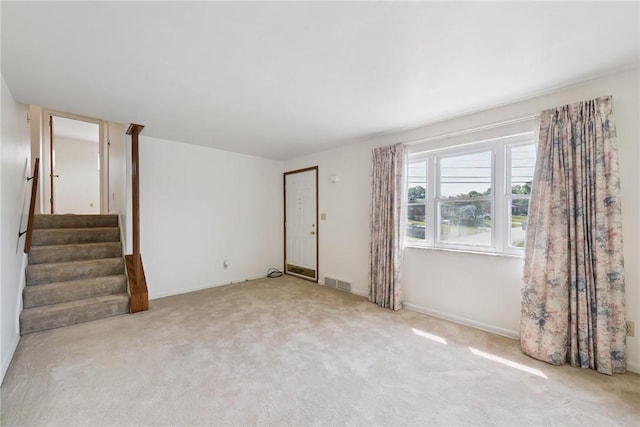 409 Westland Dr, Hempfield Twp, PA 15601 - unfurnished living room featuring carpet floors and stairs