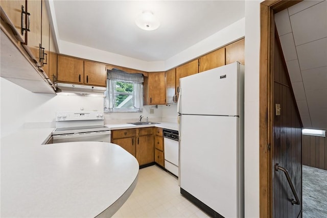 409 Westland Dr, Hempfield Twp, PA 15601 - kitchen featuring white appliances, under cabinet range hood, brown cabinets, light countertops, and light floors