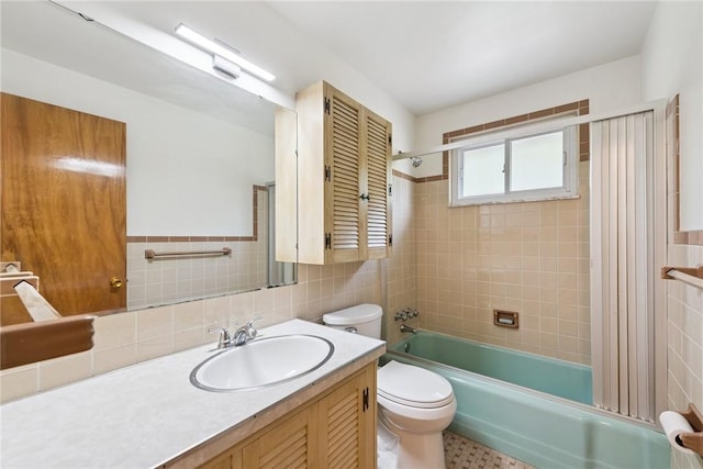 409 Westland Dr, Hempfield Twp, PA 15601 - full bath featuring vanity, tile walls, and tub / shower combination