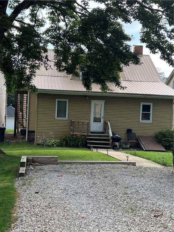 613 Third St, City Of But Ne, PA 16001 - back of house with a metal roof, a yard, and a chimney