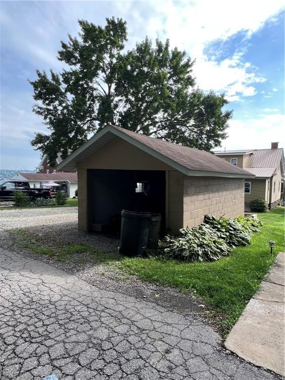613 Third St, City Of But Ne, PA 16001 - view of side of property with concrete block siding and an outdoor structure