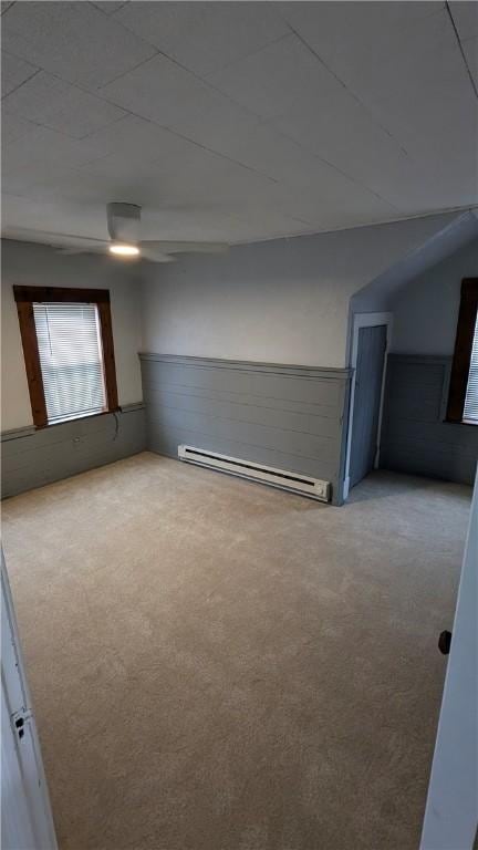 613 Third St, City Of But Ne, PA 16001 - spare room featuring baseboard heating, carpet, and a wainscoted wall
