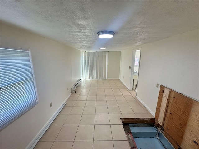 1023 Burtner Rd, Harrison Twp, PA 15065 - empty room with baseboard heating, a textured ceiling, and light tile patterned floors