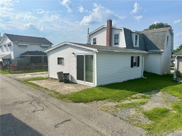 1023 Burtner Rd, Harrison Twp, PA 15065 - rear view of house featuring a gambrel roof, roof with shingles, and a chimney