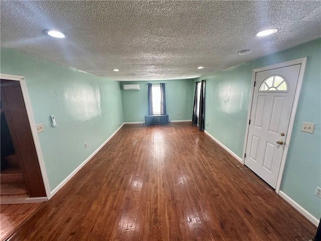 1023 Burtner Rd, Harrison Twp, PA 15065 - entrance foyer featuring a textured ceiling, an AC wall unit, wood finished floors, and recessed lighting