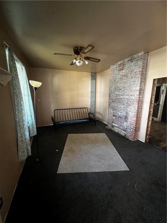 219 Sherman Ave, Vandergrift, PA 15690 - unfurnished room featuring ceiling fan, dark colored carpet, and brick wall