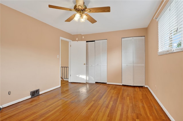 233 Ingram Ave, Ingram, PA 15205 - unfurnished bedroom featuring multiple closets, light wood finished floors, and a ceiling fan