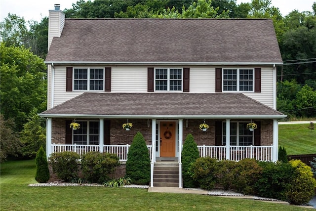 405 Crestridge Dr, Hempfield Twp, PA 15601 - view of front facade featuring a porch, a chimney, a front yard, and brick siding