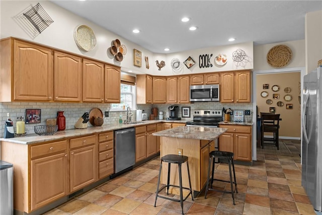 405 Crestridge Dr, Hempfield Twp, PA 15601 - kitchen with appliances with stainless steel finishes, tasteful backsplash, a kitchen island, recessed lighting, and a kitchen breakfast bar
