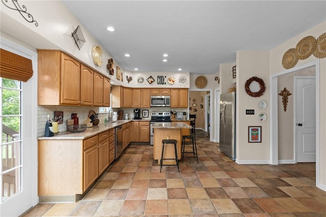 405 Crestridge Dr, Hempfield Twp, PA 15601 - kitchen with stainless steel appliances, a kitchen island, decorative backsplash, light countertops, and recessed lighting