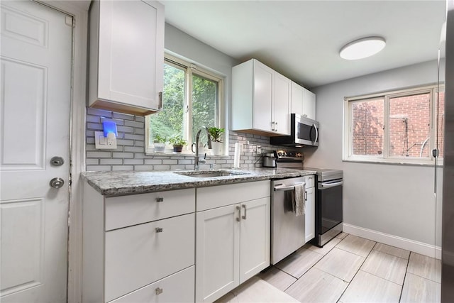 3905 Beechwood Blvd, Squirrel Hill, PA 15217 - kitchen with appliances with stainless steel finishes, decorative backsplash, white cabinets, and light stone countertops