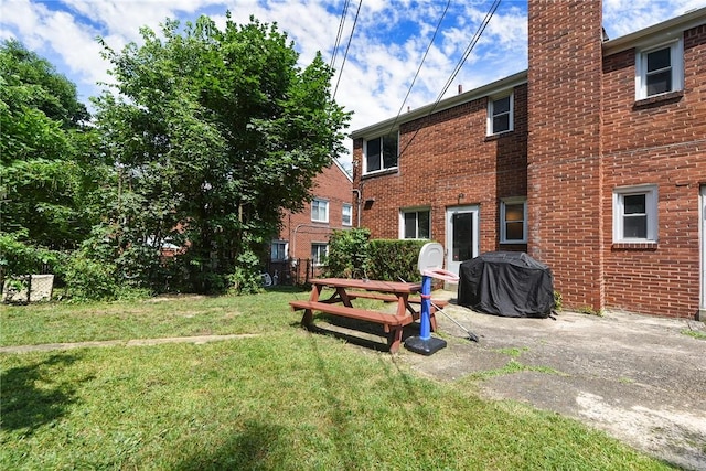3905 Beechwood Blvd, Squirrel Hill, PA 15217 - back of house featuring a yard, a chimney, brick siding, and a patio area