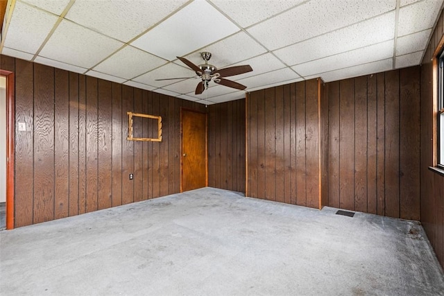 149 Frank St, Whitaker, PA 15120 - carpeted empty room featuring wooden walls, a drop ceiling, and a ceiling fan