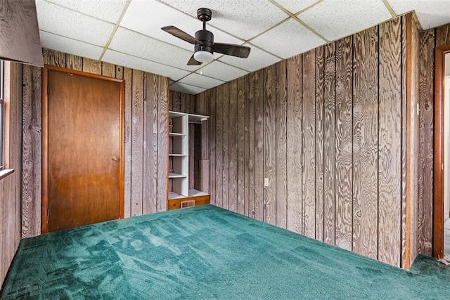 149 Frank St, Whitaker, PA 15120 - unfurnished bedroom with a drop ceiling, carpet floors, wooden walls, and ceiling fan