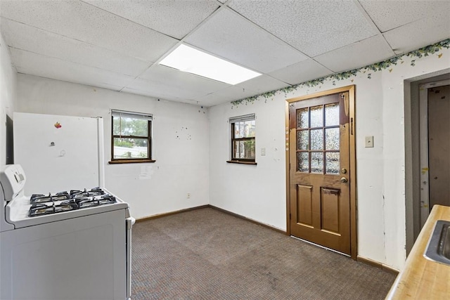 149 Frank St, Whitaker, PA 15120 - kitchen featuring white appliances, a drop ceiling, plenty of natural light, and dark colored carpet