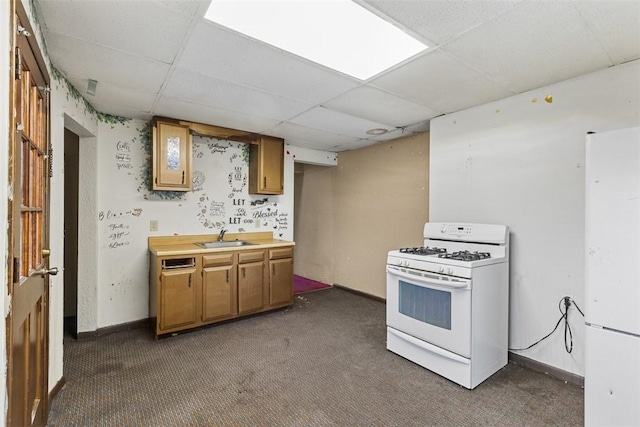 149 Frank St, Whitaker, PA 15120 - kitchen with white appliances, a paneled ceiling, dark colored carpet, brown cabinetry, and light countertops