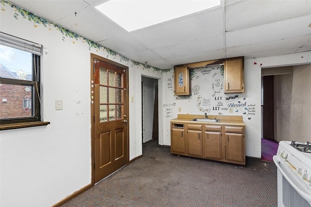 149 Frank St, Whitaker, PA 15120 - kitchen featuring a drop ceiling, white range with gas stovetop, dark colored carpet, brown cabinets, and light countertops