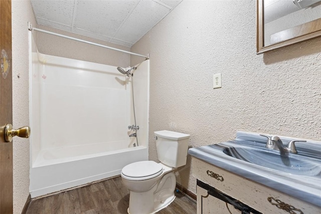 149 Frank St, Whitaker, PA 15120 - full bath featuring  shower combination, vanity, wood finished floors, and a textured wall
