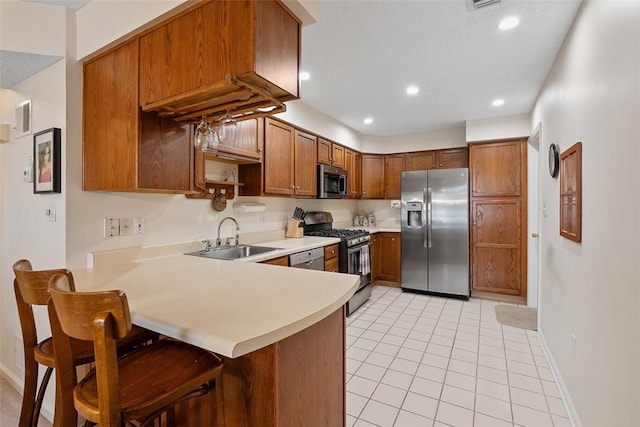 5113 Polo Fields Dr, Hampton, PA 15044 - kitchen featuring stainless steel appliances, light countertops, a peninsula, a breakfast bar, and light tile patterned floors