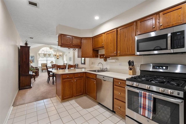 5113 Polo Fields Dr, Hampton, PA 15044 - kitchen with appliances with stainless steel finishes, brown cabinets, light countertops, and a peninsula
