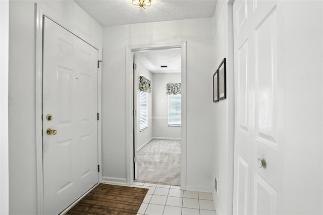5113 Polo Fields Dr, Hampton, PA 15044 - foyer featuring a textured ceiling, light tile patterned floors, and light colored carpet