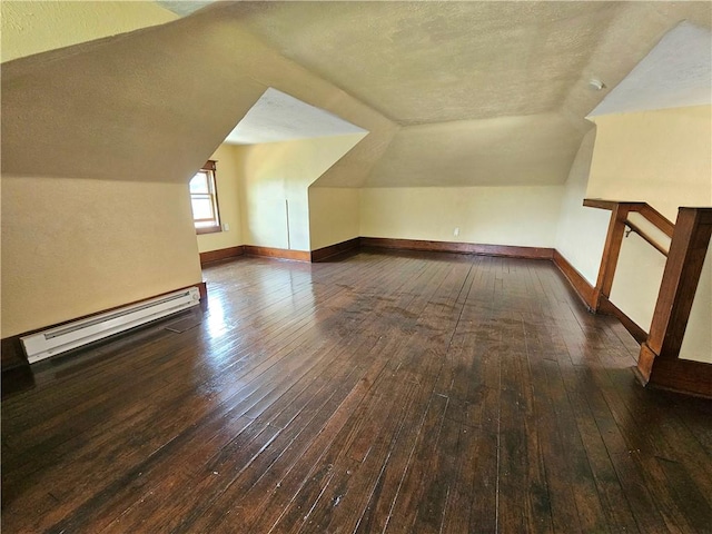 2001 7th Ave, Beaver Falls, PA 15010 - additional living space featuring a baseboard heating unit, a textured ceiling, hardwood / wood-style flooring, and vaulted ceiling