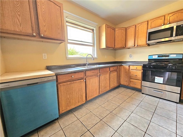 2001 7th Ave, Beaver Falls, PA 15010 - kitchen featuring stainless steel appliances, light tile patterned flooring, and dark countertops