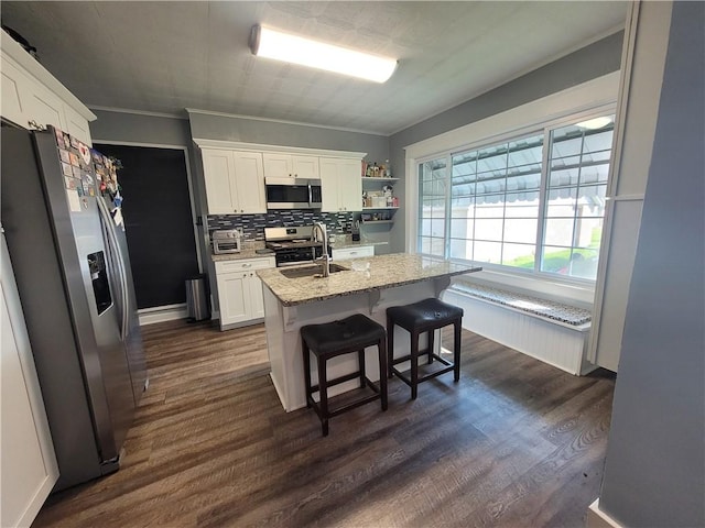 1727 Tyler St, Aliquippa, PA 15001 - kitchen with stainless steel appliances, white cabinets, dark wood finished floors, light stone countertops, and decorative backsplash