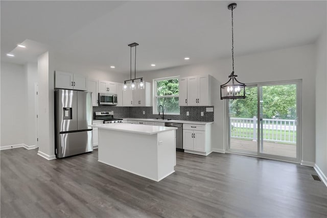 130 Center Ave, Burgettstown Boro, PA 15021 - kitchen featuring appliances with stainless steel finishes, decorative backsplash, dark wood finished floors, a center island, and recessed lighting