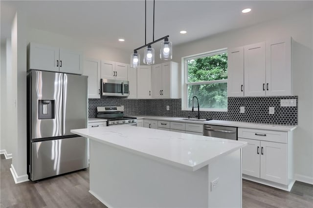 130 Center Ave, Burgettstown Boro, PA 15021 - kitchen with stainless steel appliances, wood finished floors, a center island, backsplash, and recessed lighting