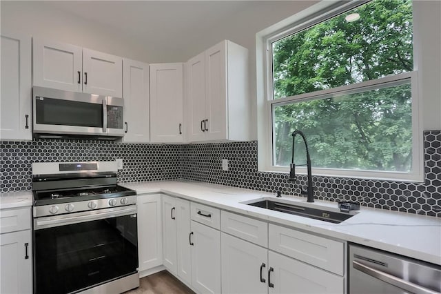 130 Center Ave, Burgettstown Boro, PA 15021 - kitchen with stainless steel appliances, decorative backsplash, and white cabinetry