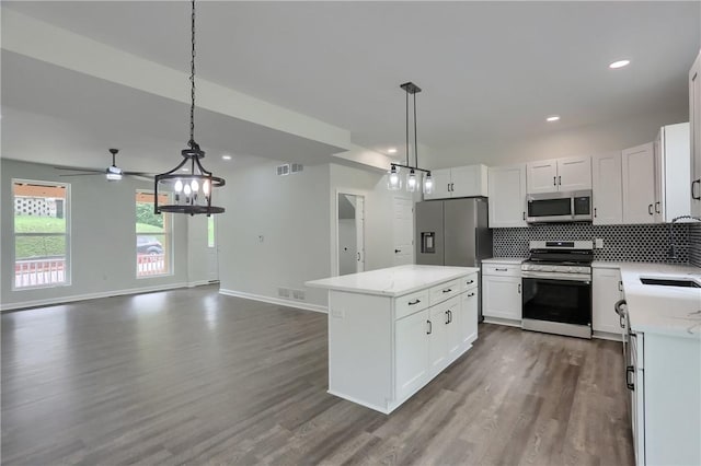 130 Center Ave, Burgettstown Boro, PA 15021 - kitchen featuring stainless steel appliances, dark wood finished floors, open floor plan, a center island, and backsplash