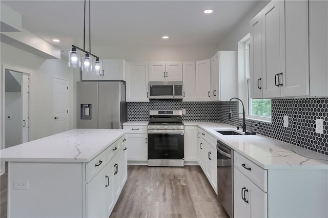 130 Center Ave, Burgettstown Boro, PA 15021 - kitchen with stainless steel appliances, light wood-type flooring, white cabinets, tasteful backsplash, and recessed lighting