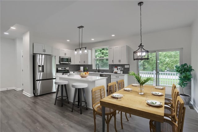 130 Center Ave, Burgettstown Boro, PA 15021 - kitchen featuring stainless steel appliances, a kitchen island, backsplash, light countertops, and dark wood-type flooring