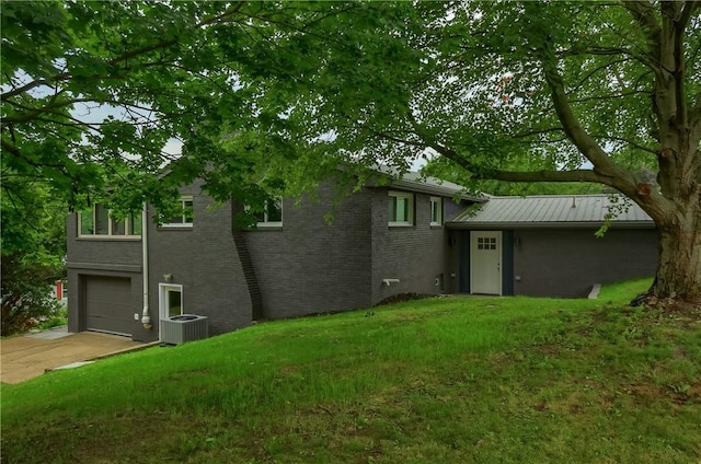 1611 18th Ave, Patterson Heights, PA 15010 - back of property featuring a garage, driveway, brick siding, and a yard