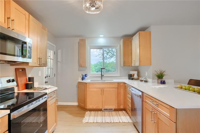 1611 18th Ave, Patterson Heights, PA 15010 - kitchen featuring stainless steel appliances, light brown cabinetry, a peninsula, light countertops, and recessed lighting