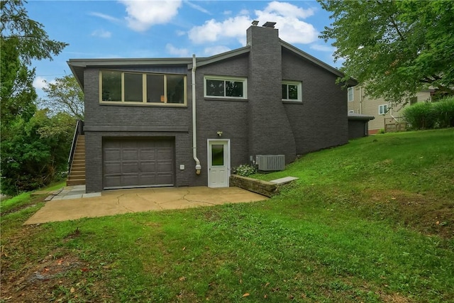 1611 18th Ave, Patterson Heights, PA 15010 - back of house featuring a chimney, a garage, a lawn, and brick siding