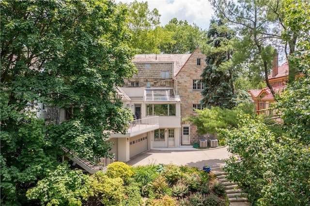 60 Longuevue Dr, Mt Lebanon, PA 15228 - rear view of house with a garage, a balcony, stairs, and stone siding