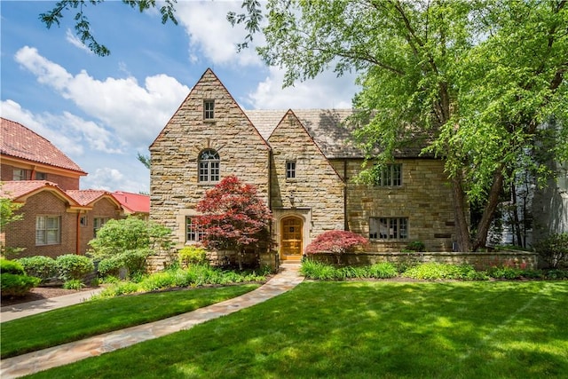 60 Longuevue Dr, Mt Lebanon, PA 15228 - tudor home with stone siding, a front yard, and a high end roof