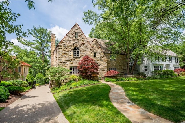 60 Longuevue Dr, Mt Lebanon, PA 15228 - tudor-style house with stone siding, a front yard, and a chimney