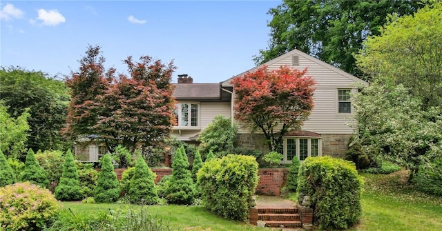 1026 Cambridge St, Harrison Twp, PA 15065 - view of front of house with a chimney, stone siding, and a front yard