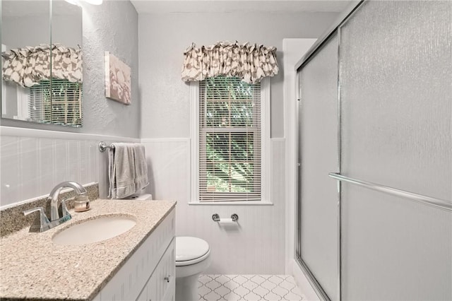 1026 Cambridge St, Harrison Twp, PA 15065 - bathroom with a stall shower, vanity, tile patterned flooring, a textured wall, and a wainscoted wall