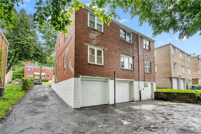1113-1115 Woodbine, Stanton Heights, PA 15201 - view of building exterior with a garage and asphalt driveway