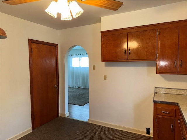 157 Elizabeth St, South Union Twp, PA 15445 - kitchen featuring a ceiling fan, arched walkways, carpet floors, and brown cabinets