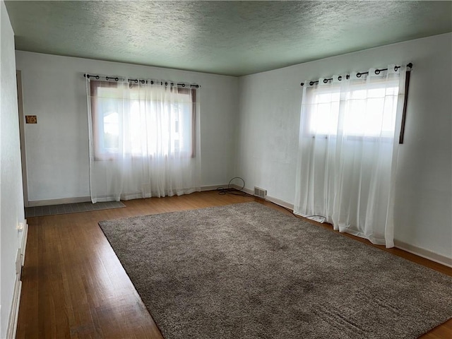 157 Elizabeth St, South Union Twp, PA 15445 - empty room with wood finished floors and a textured ceiling