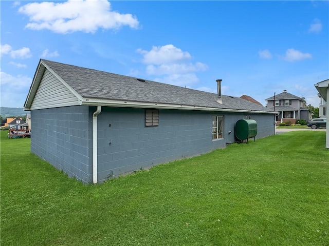979 9th St, Taylor Twp, PA 16160 - view of property exterior featuring a lawn, a shingled roof, oil tank, and concrete block siding
