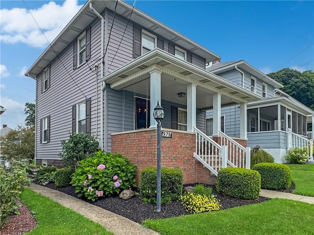 979 9th St, Taylor Twp, PA 16160 - view of front of house featuring stairs, brick siding, and a front yard