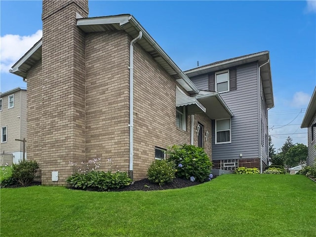 979 9th St, Taylor Twp, PA 16160 - view of home's exterior featuring a chimney and a lawn