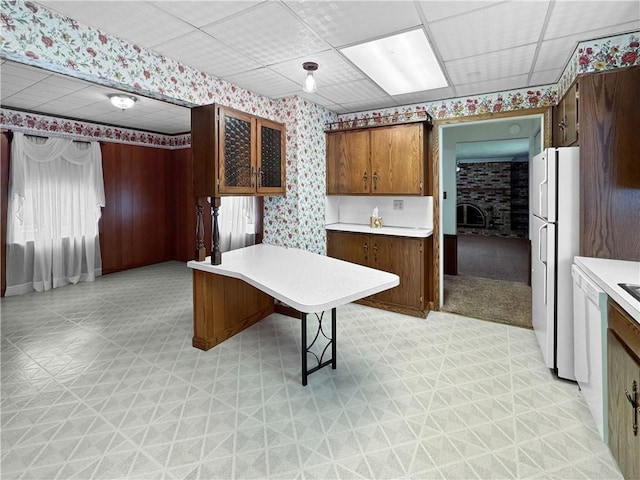 979 9th St, Taylor Twp, PA 16160 - kitchen featuring wallpapered walls, light flooring, freestanding refrigerator, light countertops, and a drop ceiling
