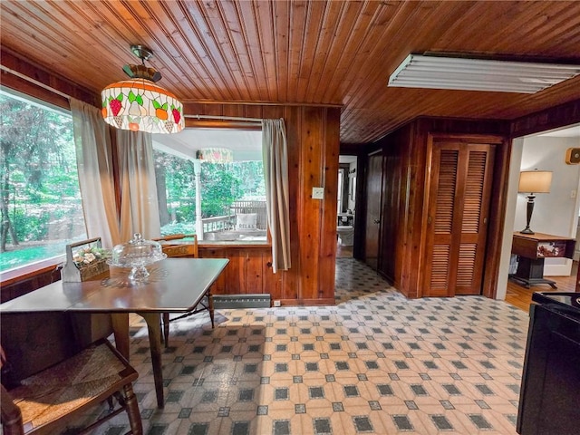 1638 Lake Rd, Pa, PA 16137 - dining area featuring wood ceiling, wood walls, healthy amount of natural light, and tile patterned floors